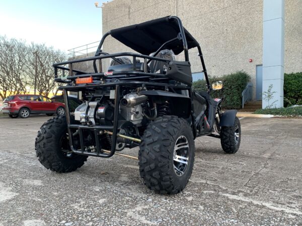 A black four wheeler parked in the parking lot.