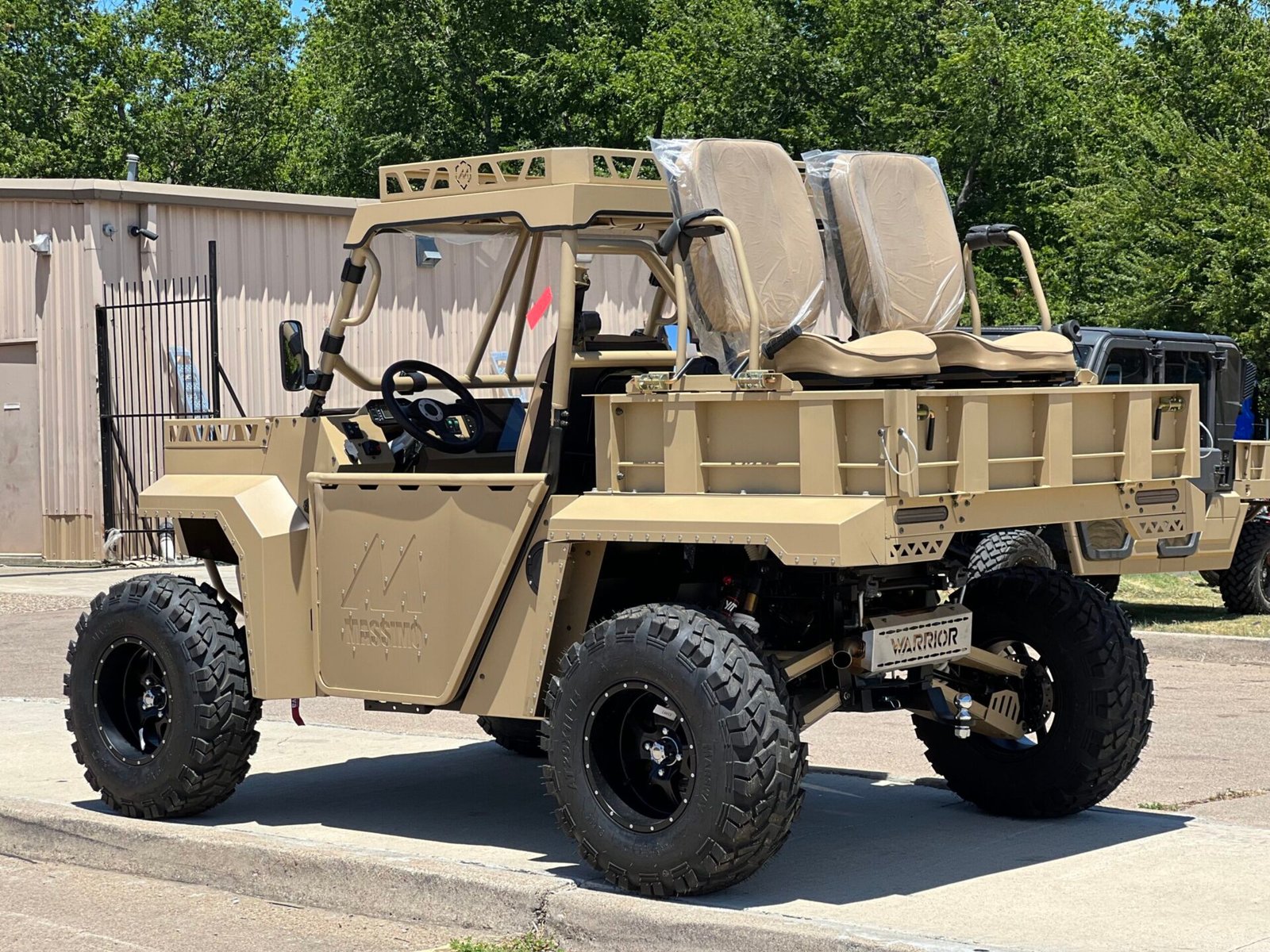 A tan utility vehicle with seats in the back.