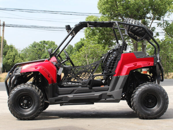 A red and black atv parked on the side of road.