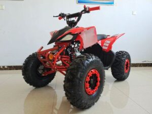 A red and black four wheeler is parked in the room.