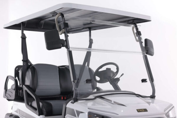 A golf cart with a windshield and seat.