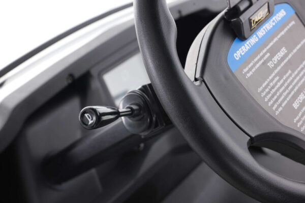 A close up of the steering wheel and controls on a car.