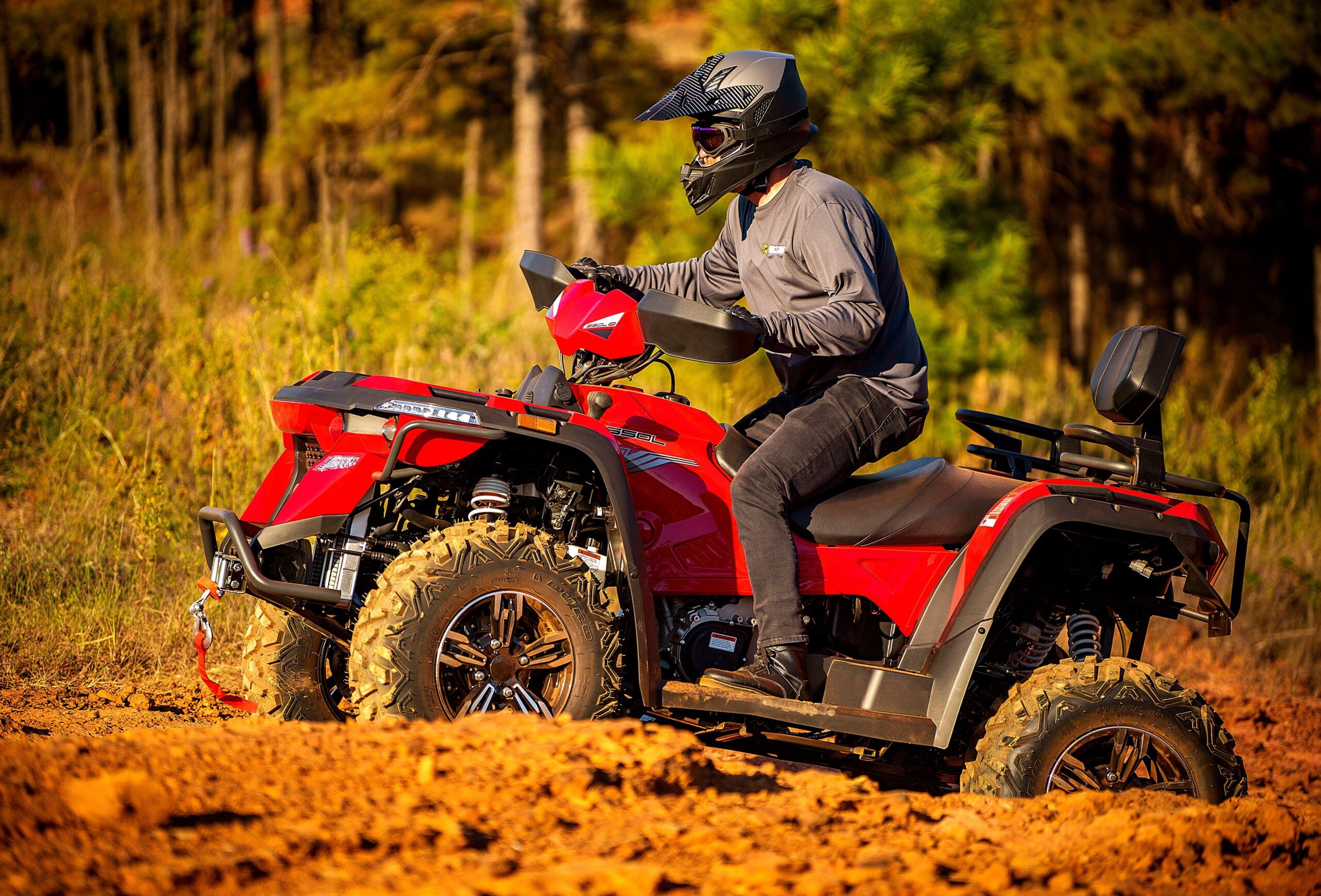 A man riding on the back of an atv.