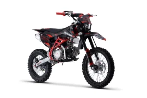 A red and black dirt bike is parked on the ground.