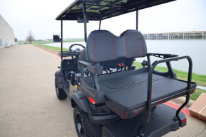 A golf cart with seats and a table on top.