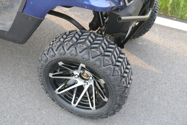 A close up of the tire on a blue atv.