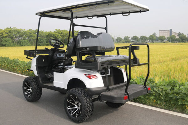 A golf cart with a large back seat and a large rear tire.