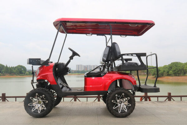 A red golf cart with large tires and a canopy.