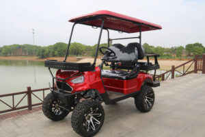 A red golf cart with large tires and a black seat.