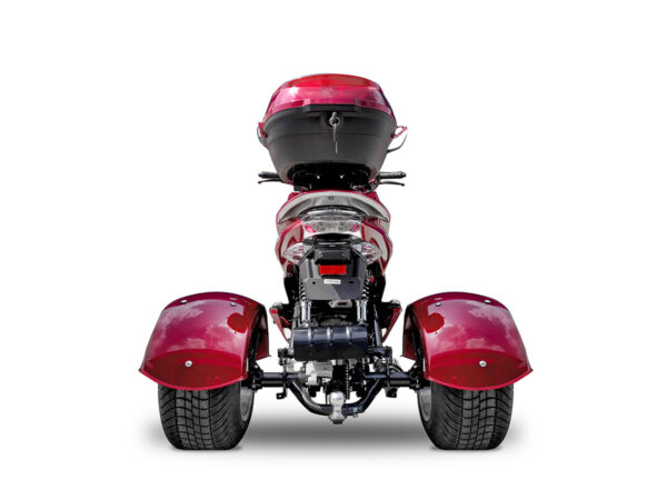 A red three wheeled motorcycle with its rear view mirror open.