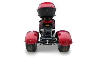 A red three wheeled motorcycle with its back wheels up.