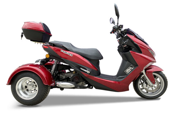 A red three wheeled motorcycle is parked on the ground.