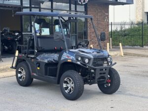A black golf cart parked in front of a building.