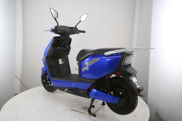 A blue scooter is parked on the table