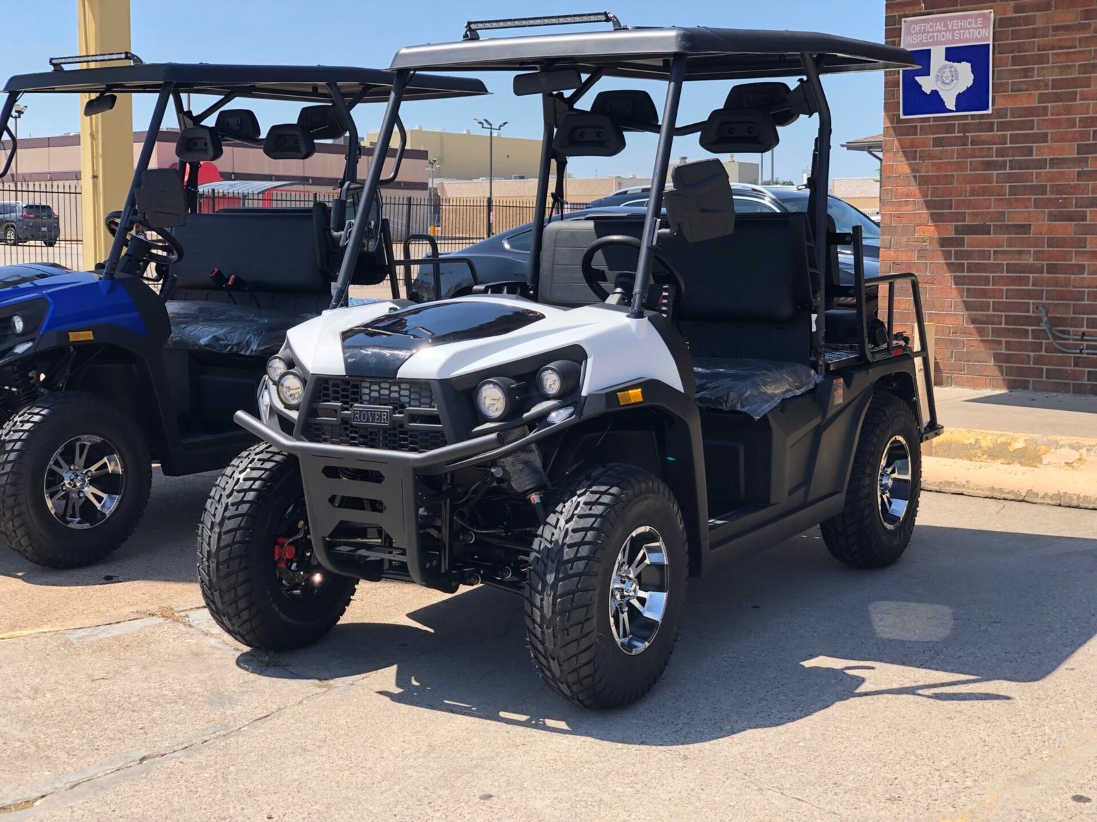 A white golf cart parked in the parking lot.