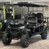 A black golf cart with lots of wheels and tires.