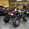 A red and black atv parked in a room.