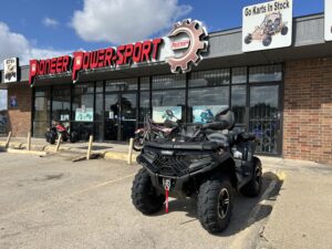 A black four wheeler parked in front of a store.