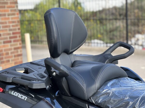 A motorcycle seat with the back rest up.