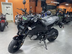 A motorcycle parked in a room with other motorcycles.