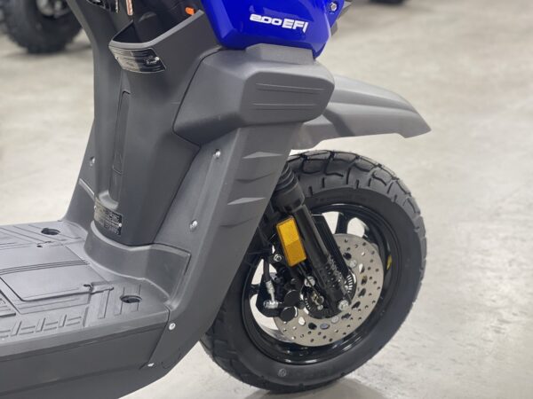 A close up of the front wheel on a scooter