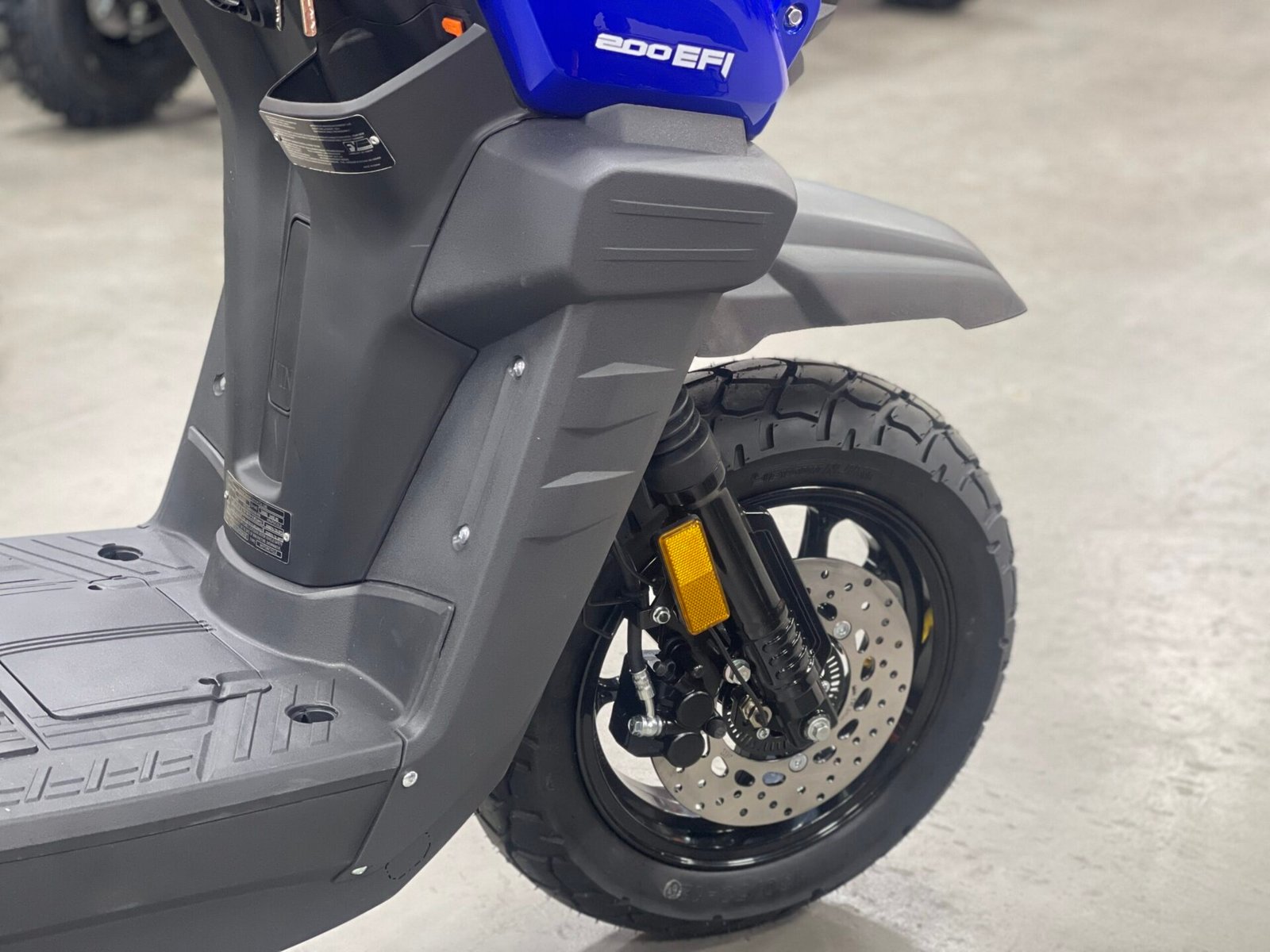 A close up of the front wheel on a scooter
