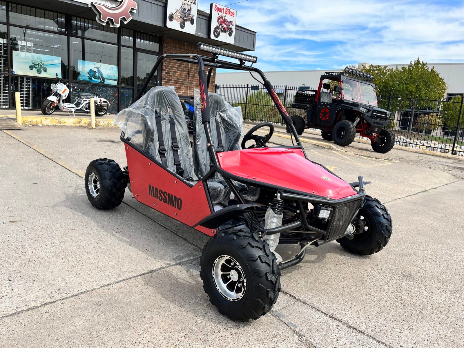 A red and black buggy is parked on the street
