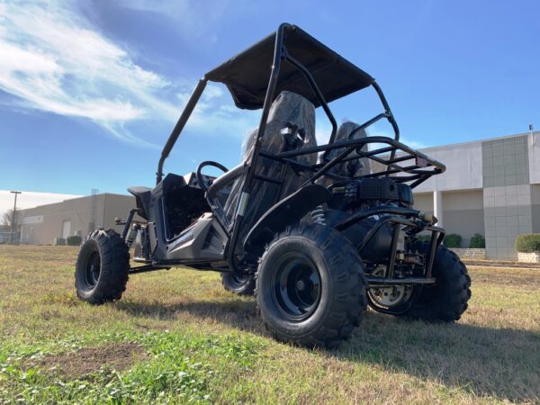 A black buggy is parked in the grass.