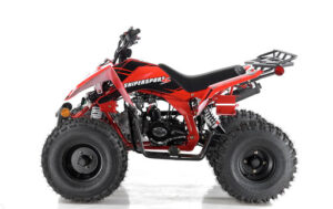 A red atv is parked on the ground.