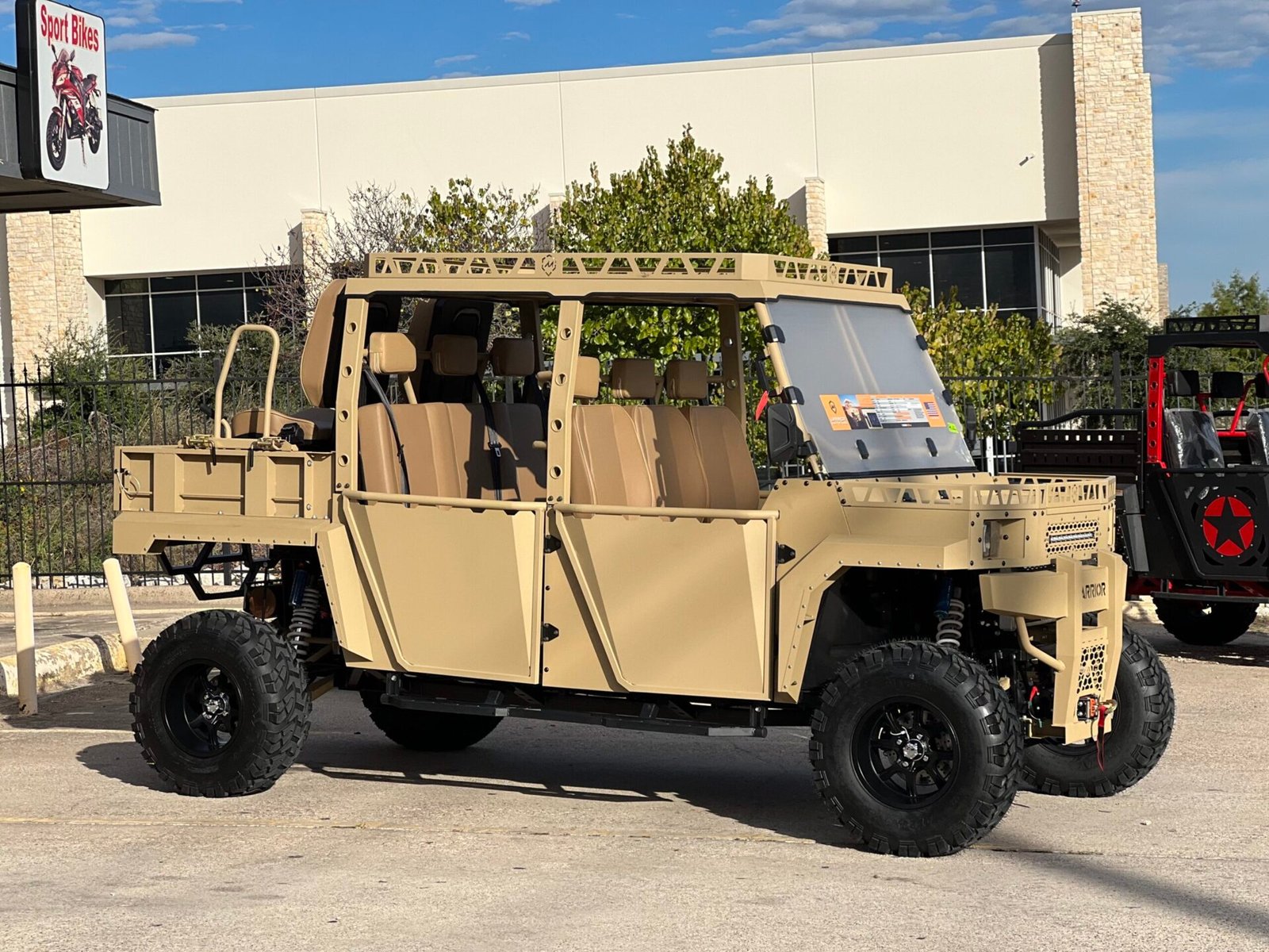 A military vehicle parked in front of a building.