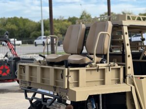 A military vehicle with two seats on the back.