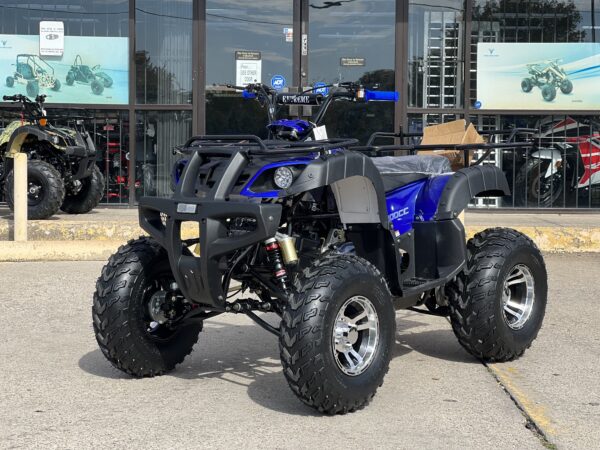 A blue and black atv parked in front of a building.