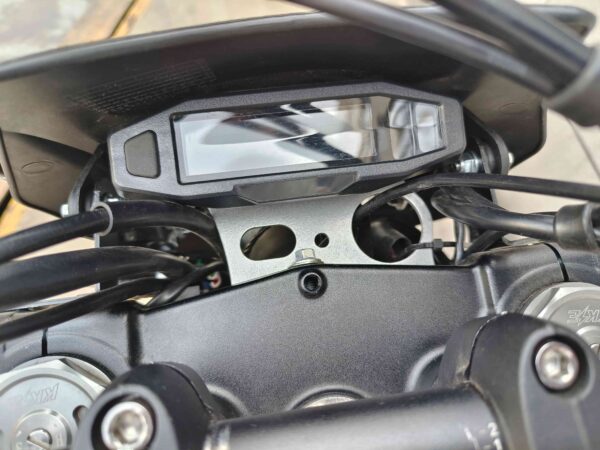 A motorcycle is shown with the mirror and controls on it.