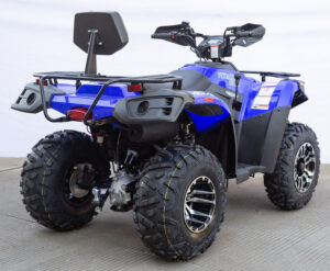 A blue and black atv parked on the cement.