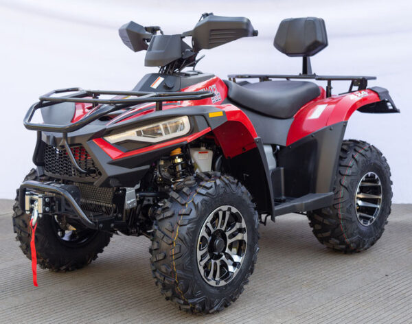A red four wheeler with black tires and a seat.