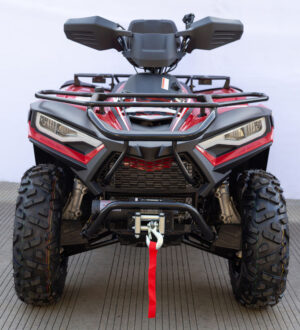 A red and black atv parked on the ground.