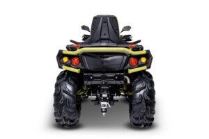 A black and yellow four wheeler is parked on the ground.