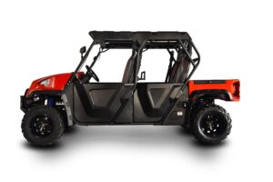 A red and black four-passenger utv parked in the sun.